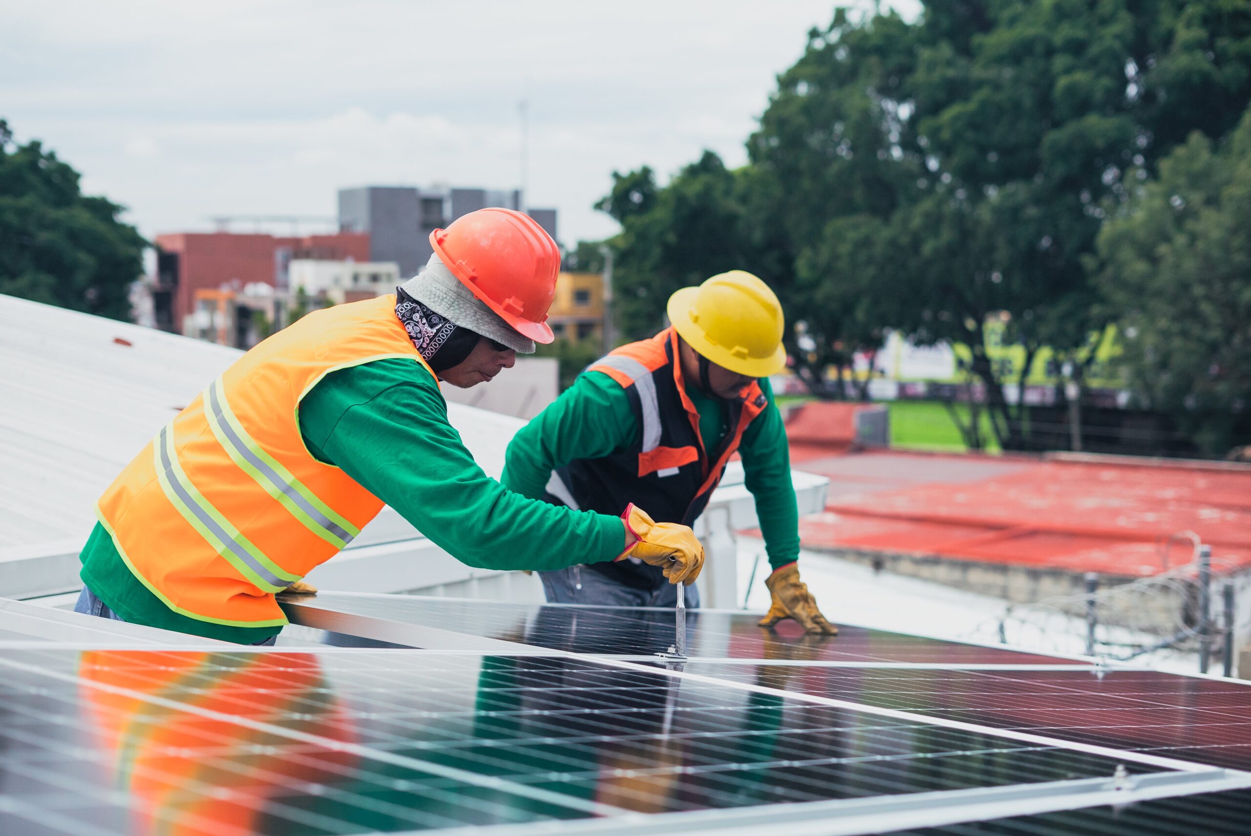 Tradespeople working on solar panels in NB