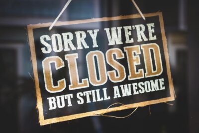 "Sorry we're closed but still awesome" sign in the window of a seasonal business